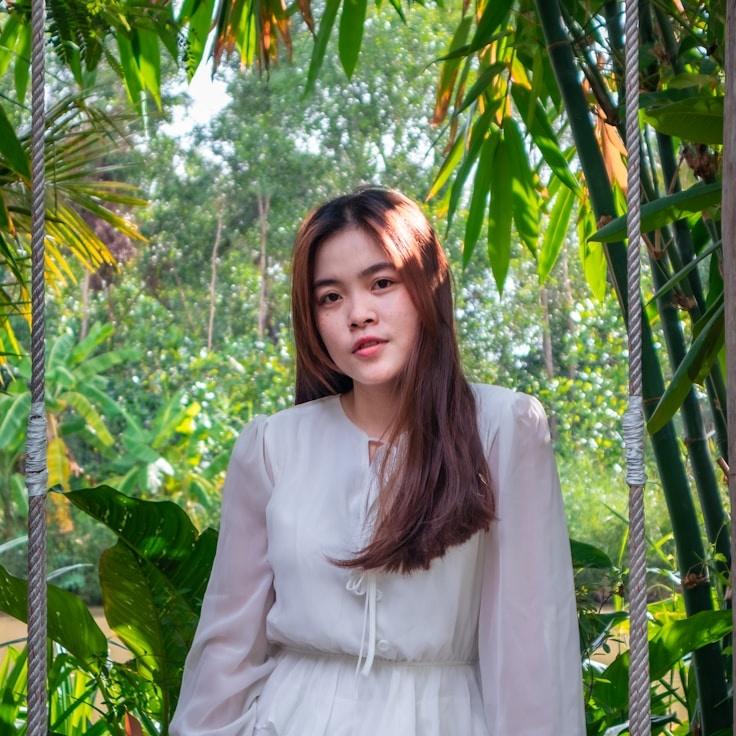 Kaveri Mehta, Lead Design Curator at OakMeadowGoods, reviewing corporate floral arrangements